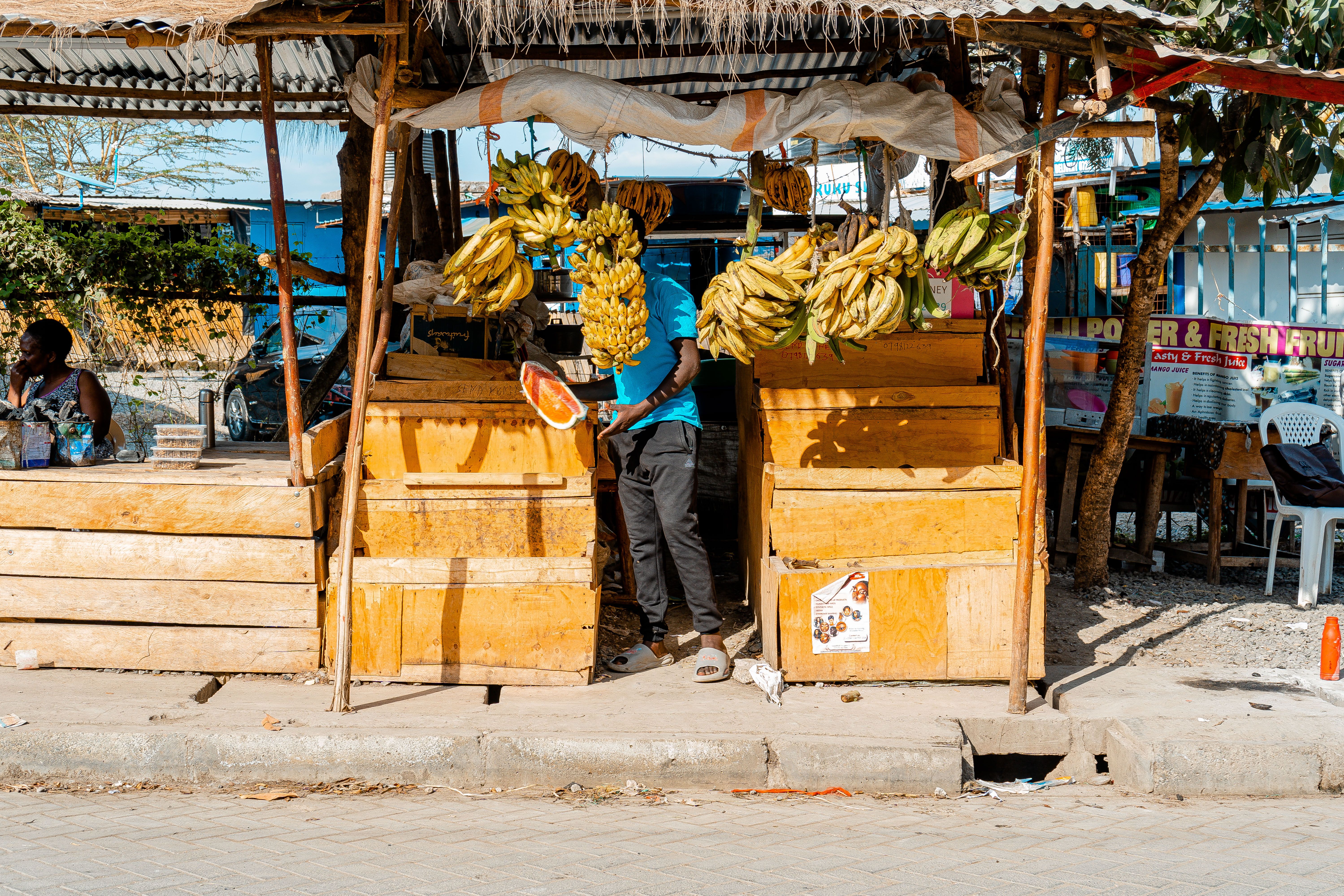 A fruit vendor working at a roadside market in Nairobi